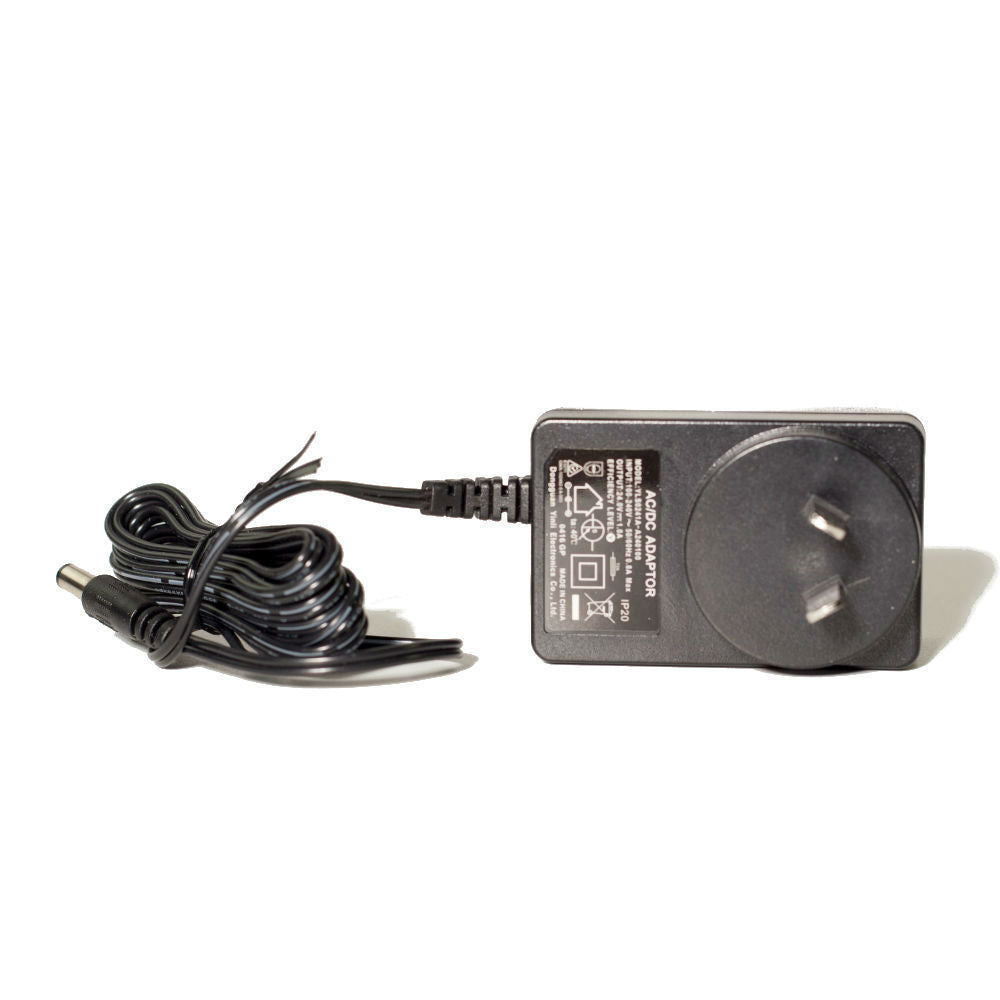 Black power adapter with coiled cable on a white background