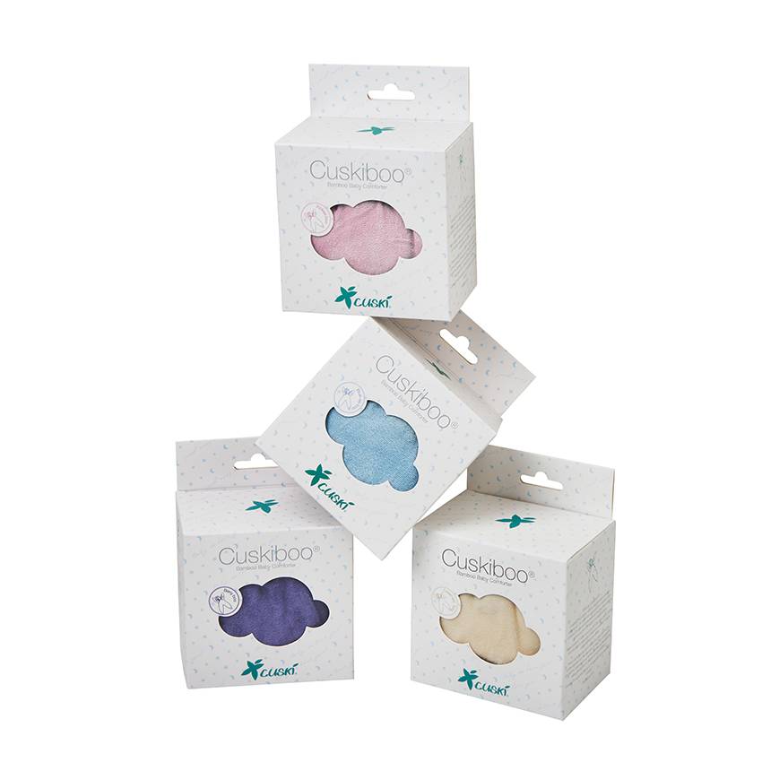 Four Cuskiboo baby comforters in white packaging, showing the pink, blue, purple, and beige cloud-shaped toys through the window cutouts.