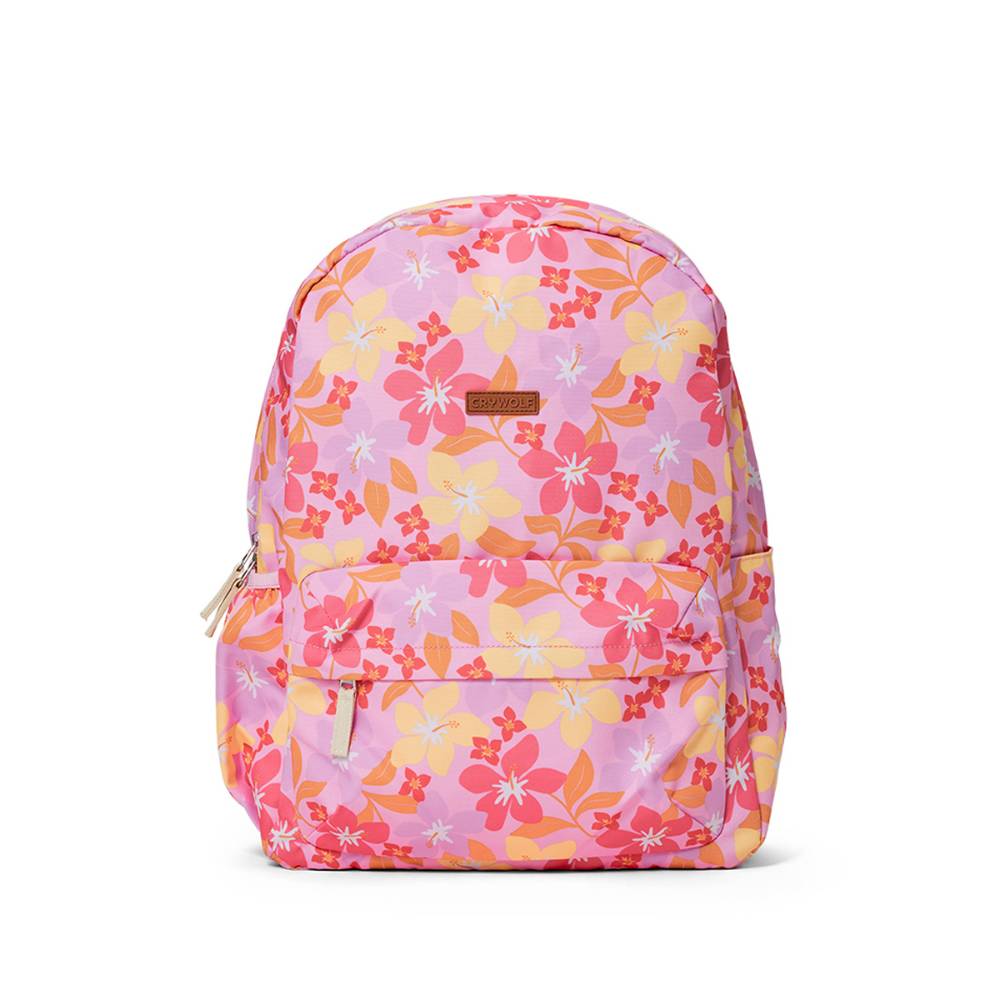 A pink backpack with a vibrant floral print in shades of orange, yellow, and red, featuring a front zippered pocket and a small brown leather brand patch.