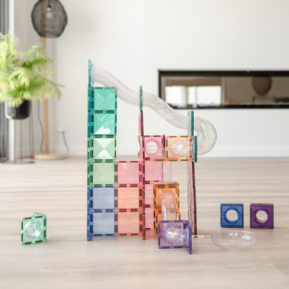 Colorful geometric blocks on a wooden floor with a blurred indoor background