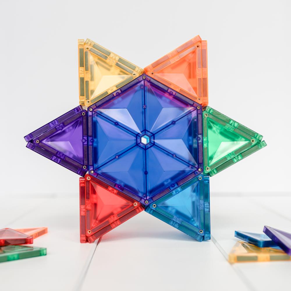 Colorful Connetix geometric transparent building blocks on a white background