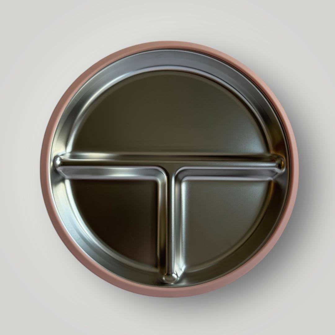 A round stainless steel divided baby plate with a rose gold outer rim, shown from a top-down perspective on a light gray background.