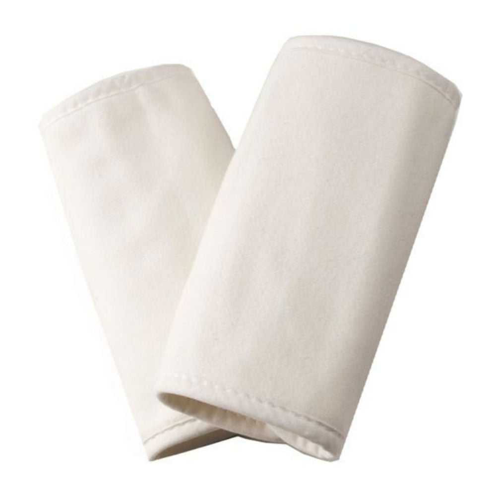 Two cream carrier teething pads on a white background