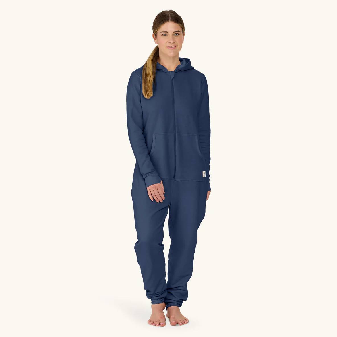 Woman wearing a navy blue hoodie and pants on a white background