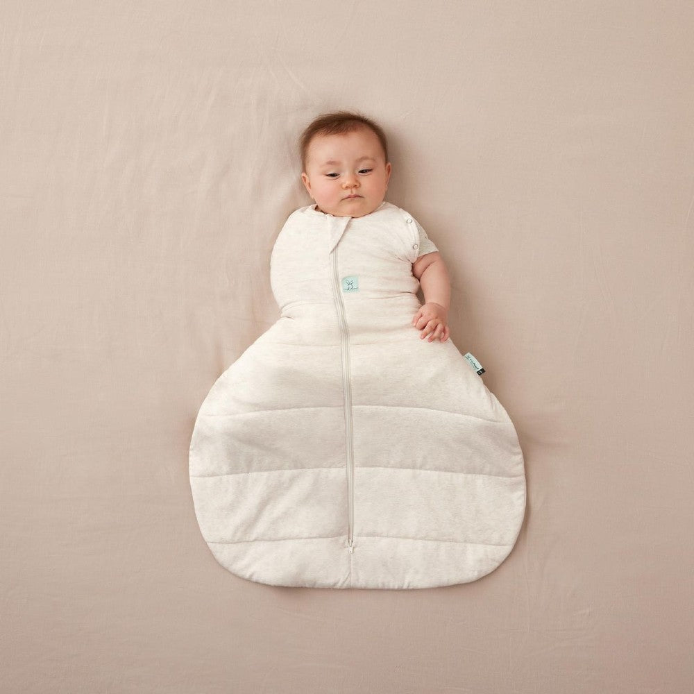 Beige baby hip dysplasia sleeping bag with a zipper on a beige background