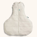 Beige hip friendly wide baby swaddle bag on a white background