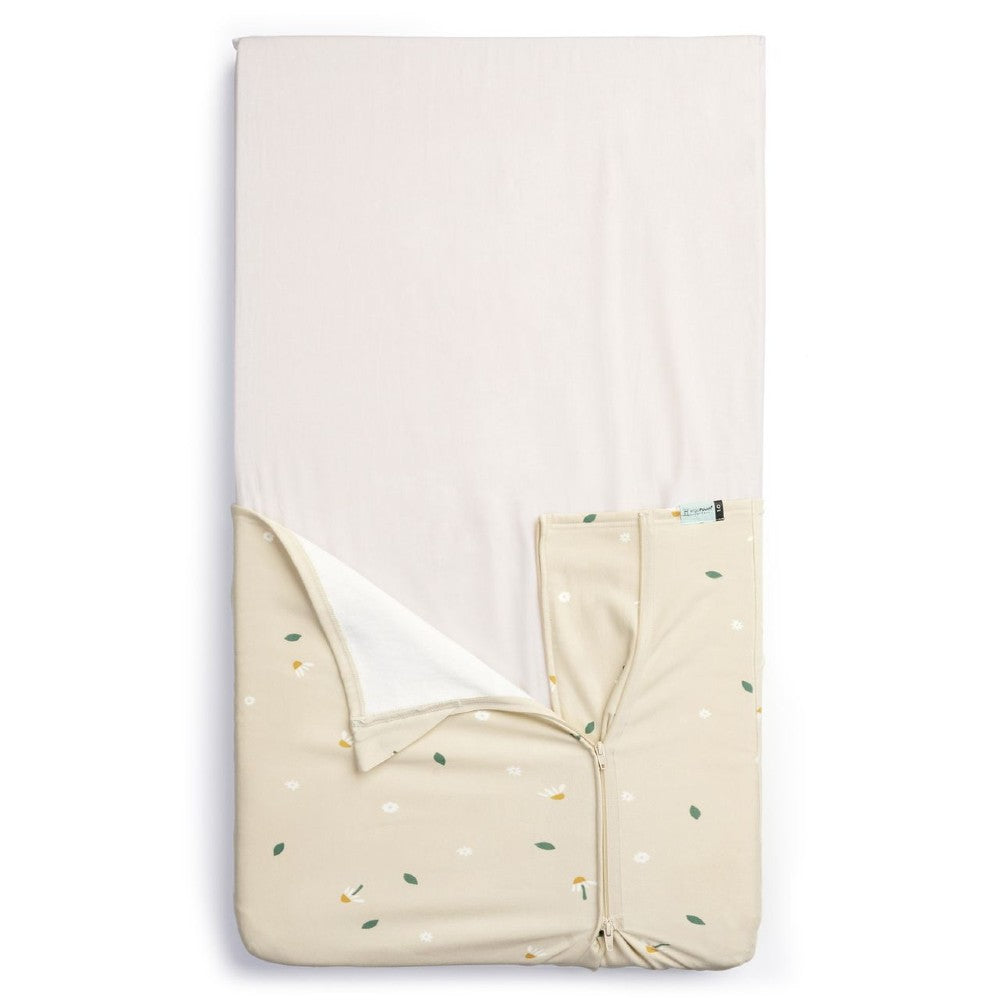 HugMe Blanket in Daisy Sprinkle pattern on a mattress on white background
