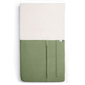 HugMe Blanket in Moss pattern on a mattress on white background