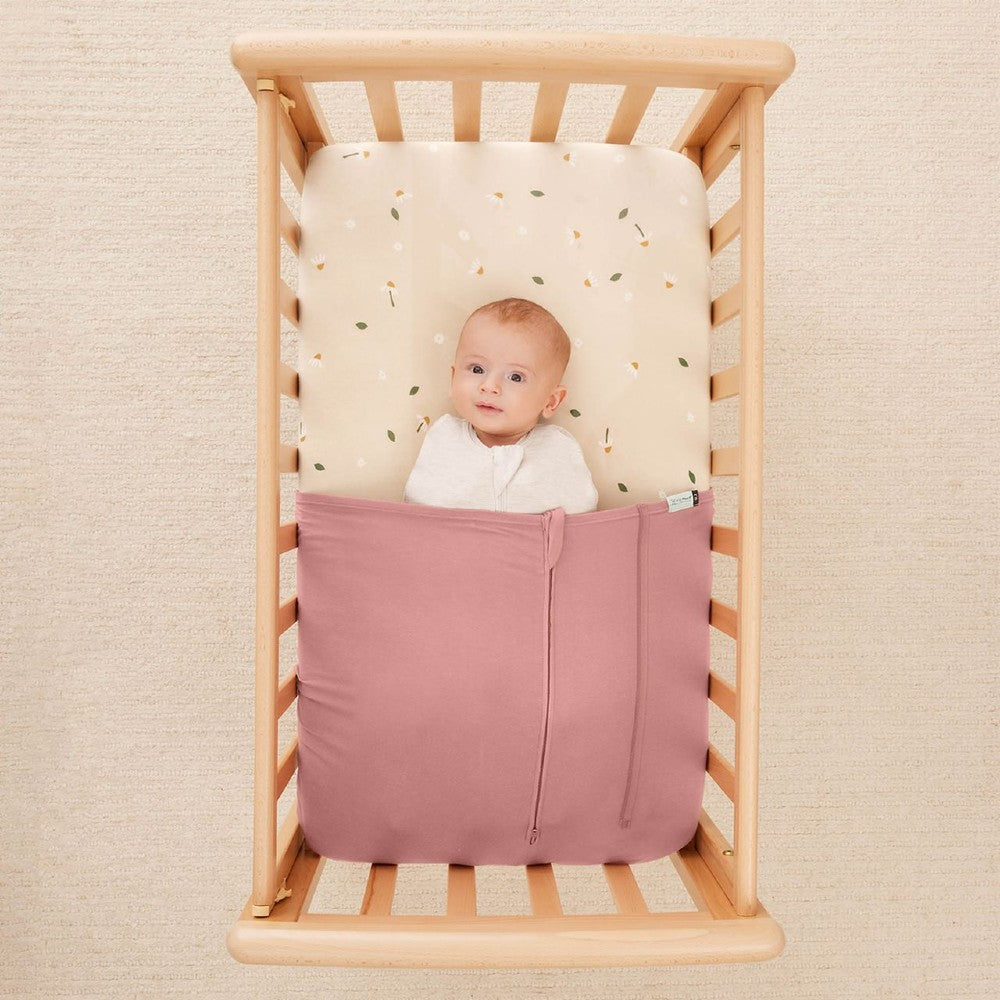 HugMe Blanket in Rose pattern on a mattress on white background