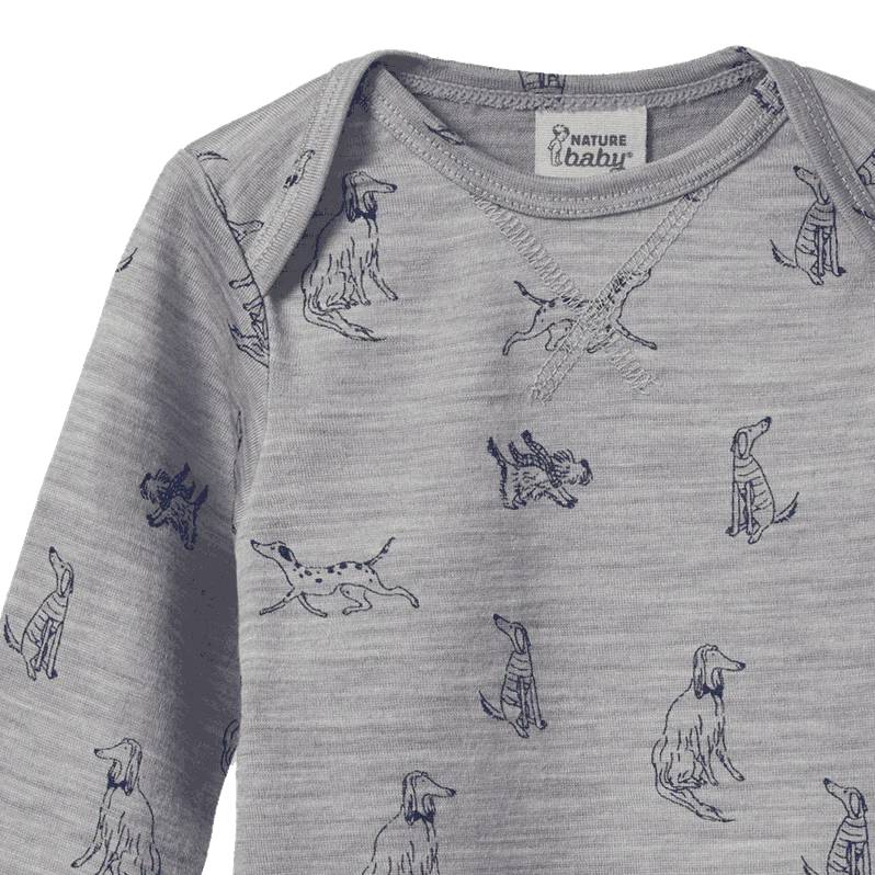Close-up of Grey merino baby shirt with dog pattern and 'Nature Baby' label on a white background