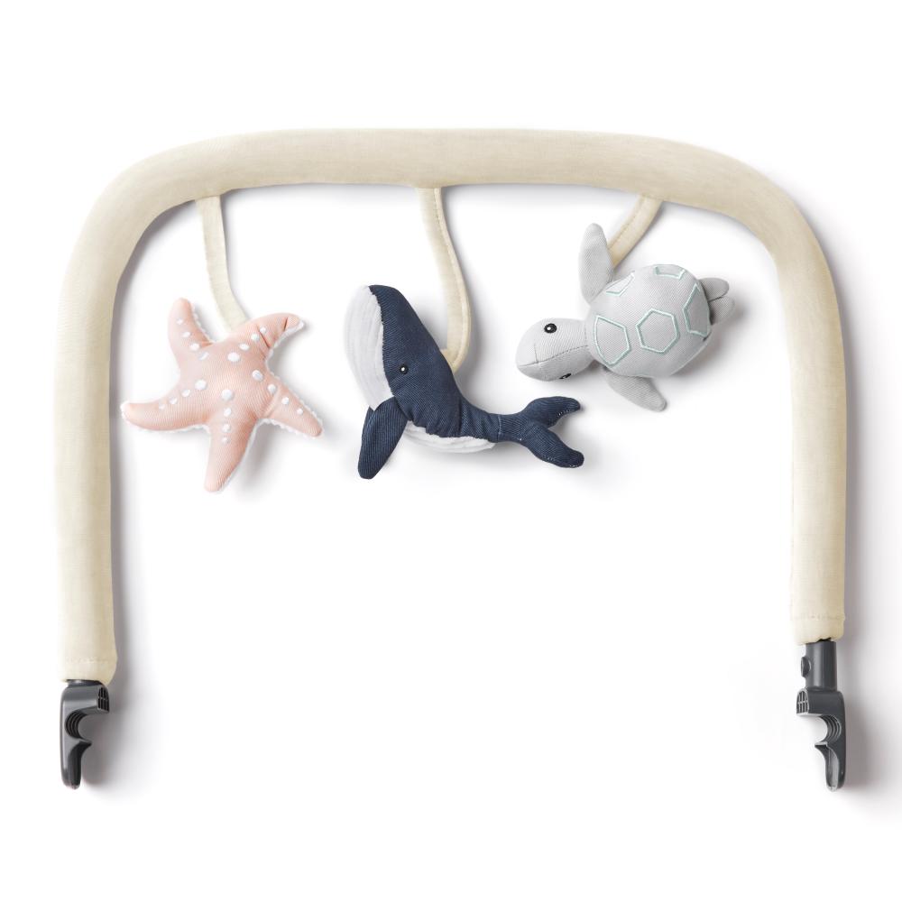 Baby gym bar with plush toys including a shark, turtle, and starfish on a white background