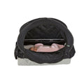 A black baby travel seat bassinet with a pop-up canopy, shown with a baby lying inside wearing a pink outfit. The bassinet has a black canopy and a light gray base, photographed against a solid white background.