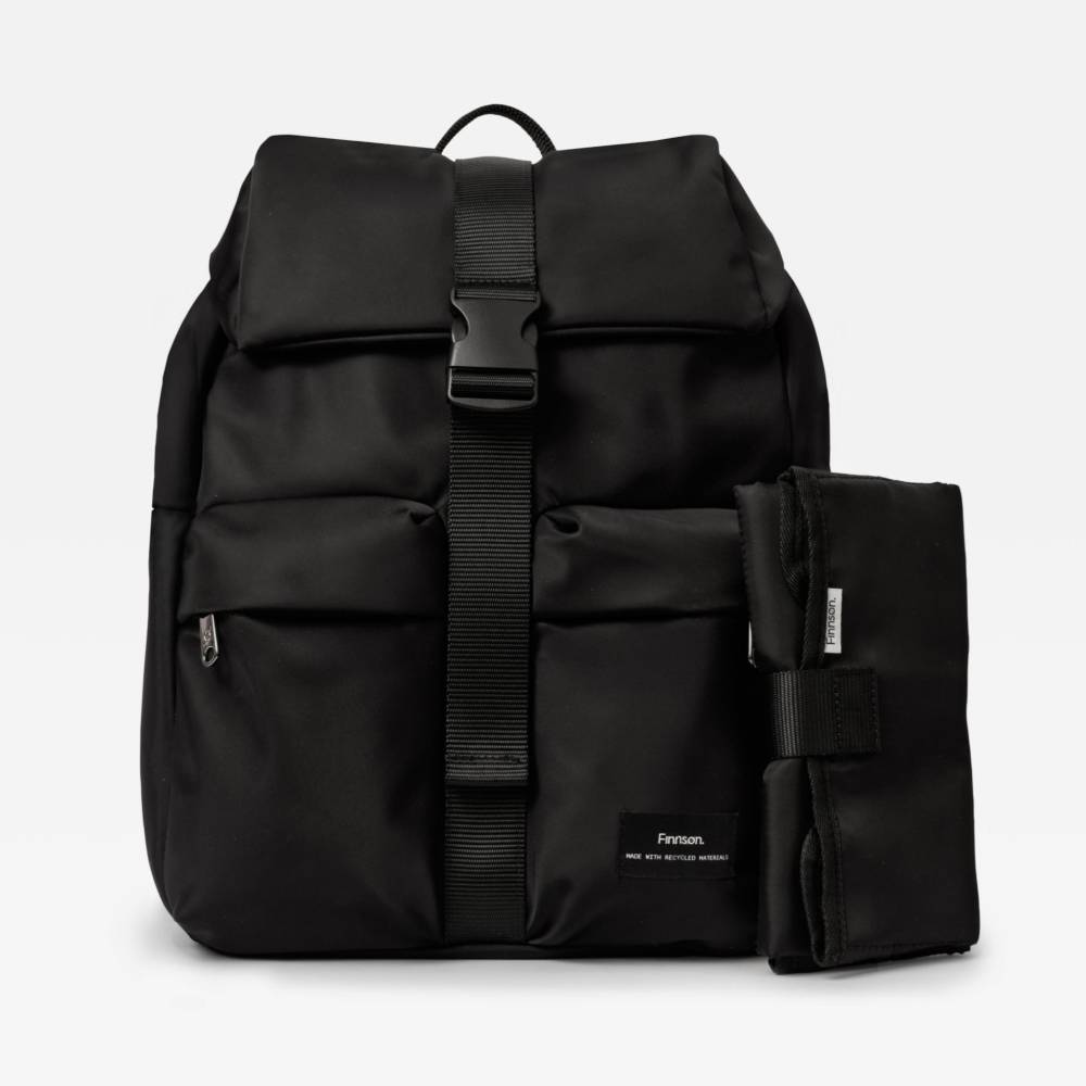Fashion black nappy backpack with a change mat included on a light gray background