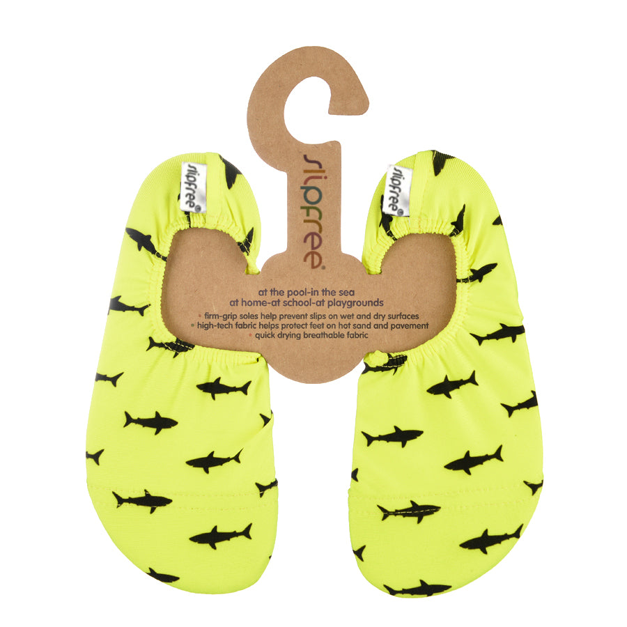 Neon yellow slipfree shoe with black shark pattern on a hanger with ' Slipfree' branding.