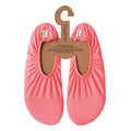 Pair of pink slip-on shoes on a hanger with 'slipfree' branding.