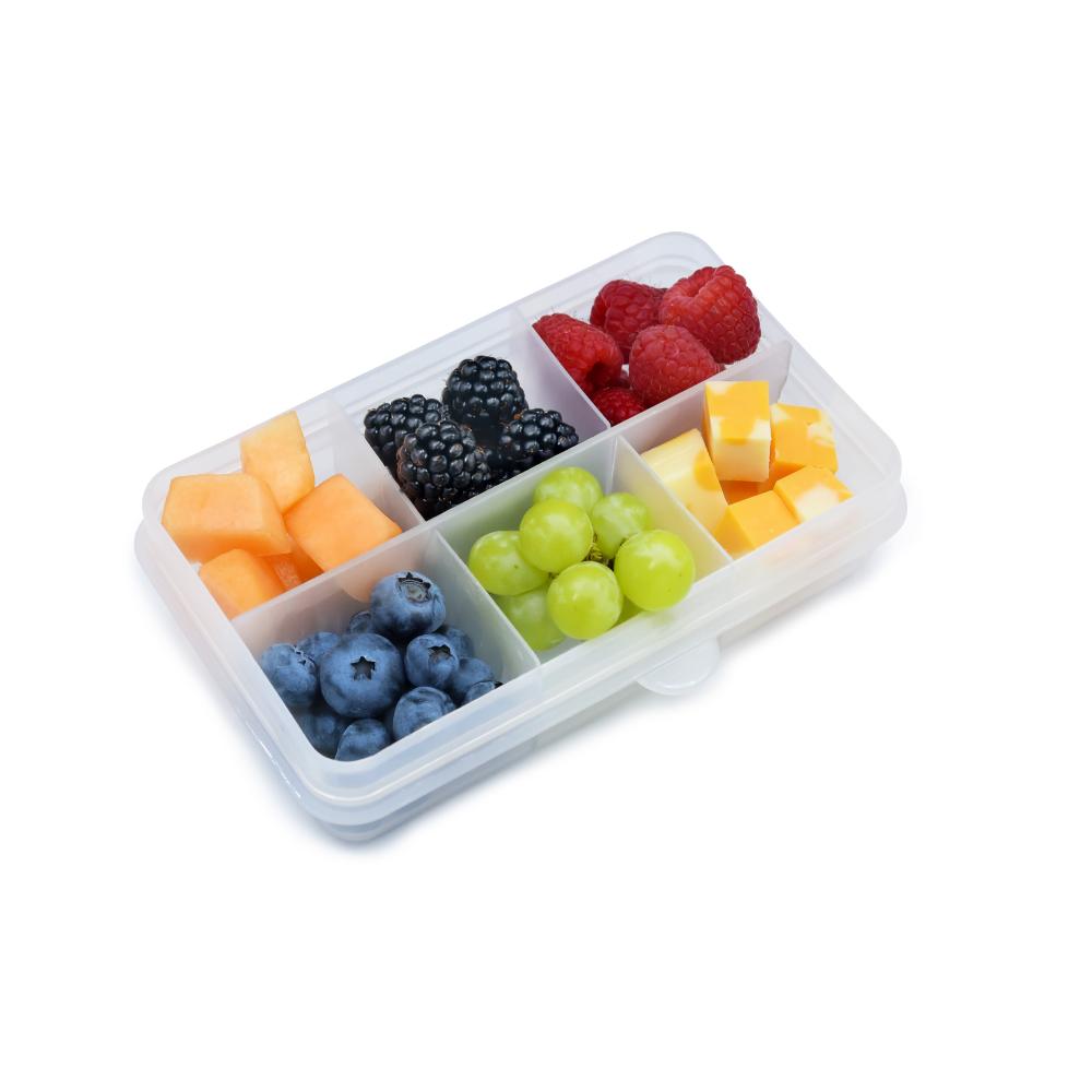 Fruit compartmentalized container with compartments filled with various fruits on a white background
