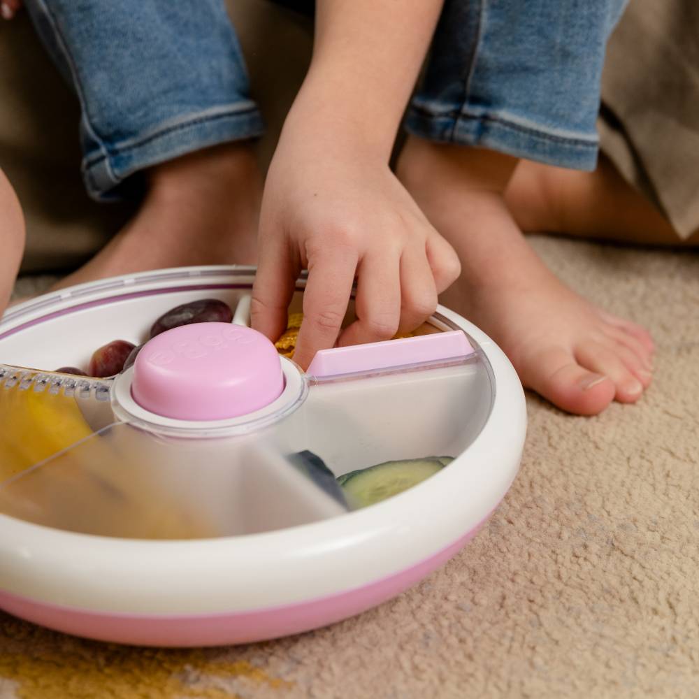 Child using white Gobe snack spinner.