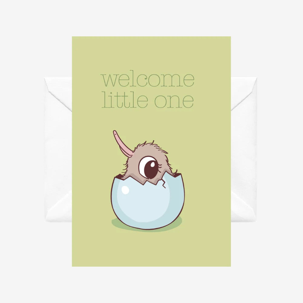 A green card with a white envelope behind it. The card has a baby kiwi hatching from an egg with the words WELCOME LITTLE ONE at the top. 