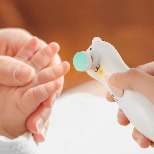 close up of baby hand with electric nail trimmer 