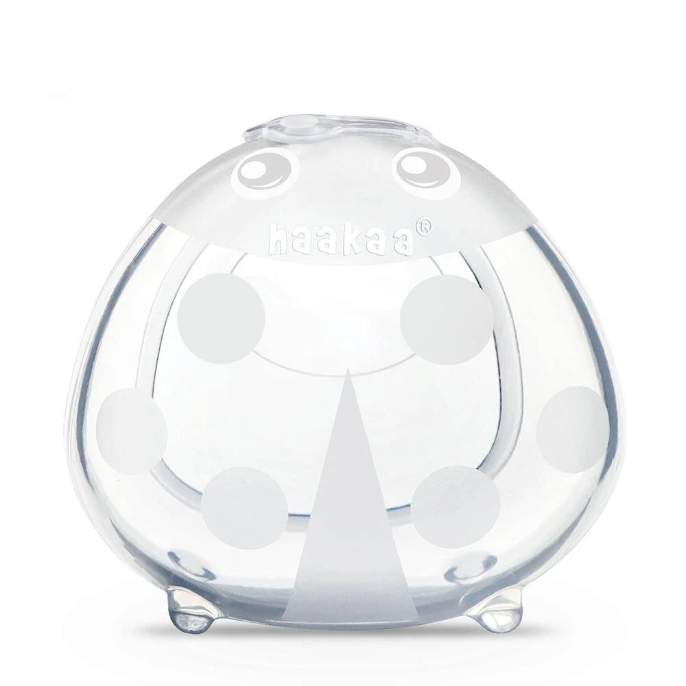 silicone breastmilk collector in ladyug shape against a white background