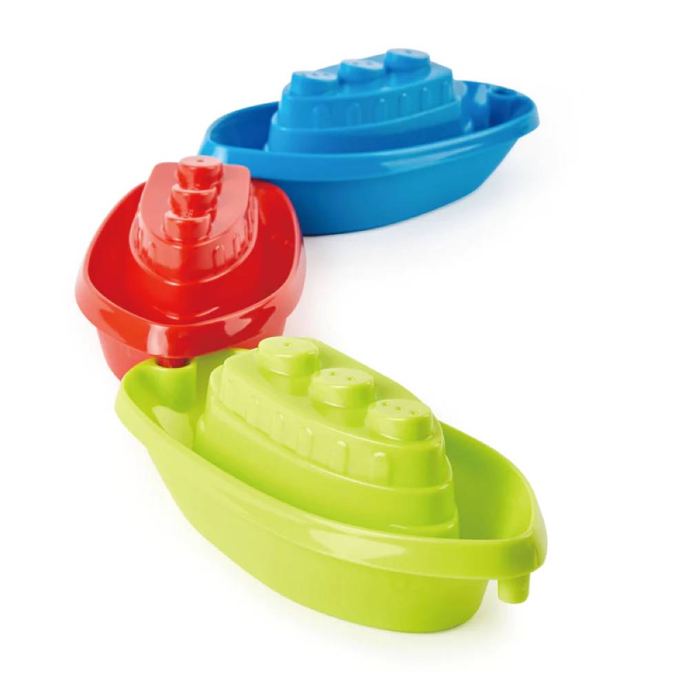Blue, green and red Hape plastic boat toys against white background.