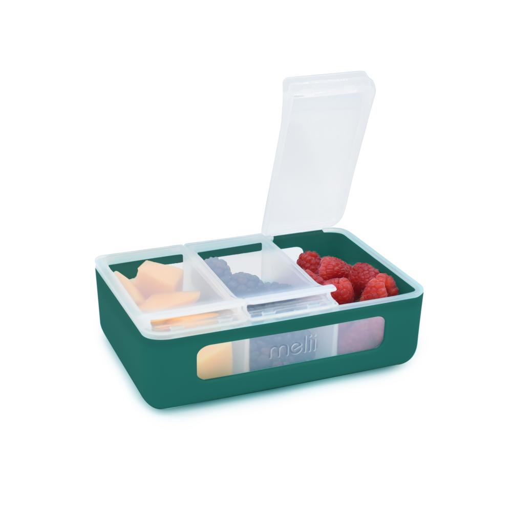 Green lunch box with compartments containing food items on a white background