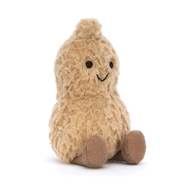 Small Jellycat peanut soft toy against white background.