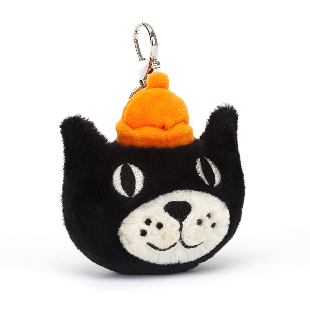 Black Jellycat cat bag charm with orange hat against white background.