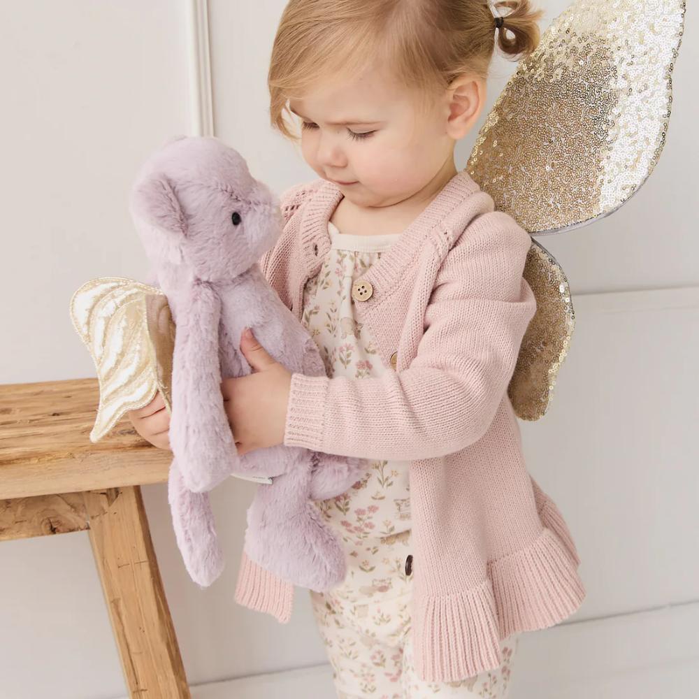 Child holding Jamie Kay purple cat soft toy with fairy wings.