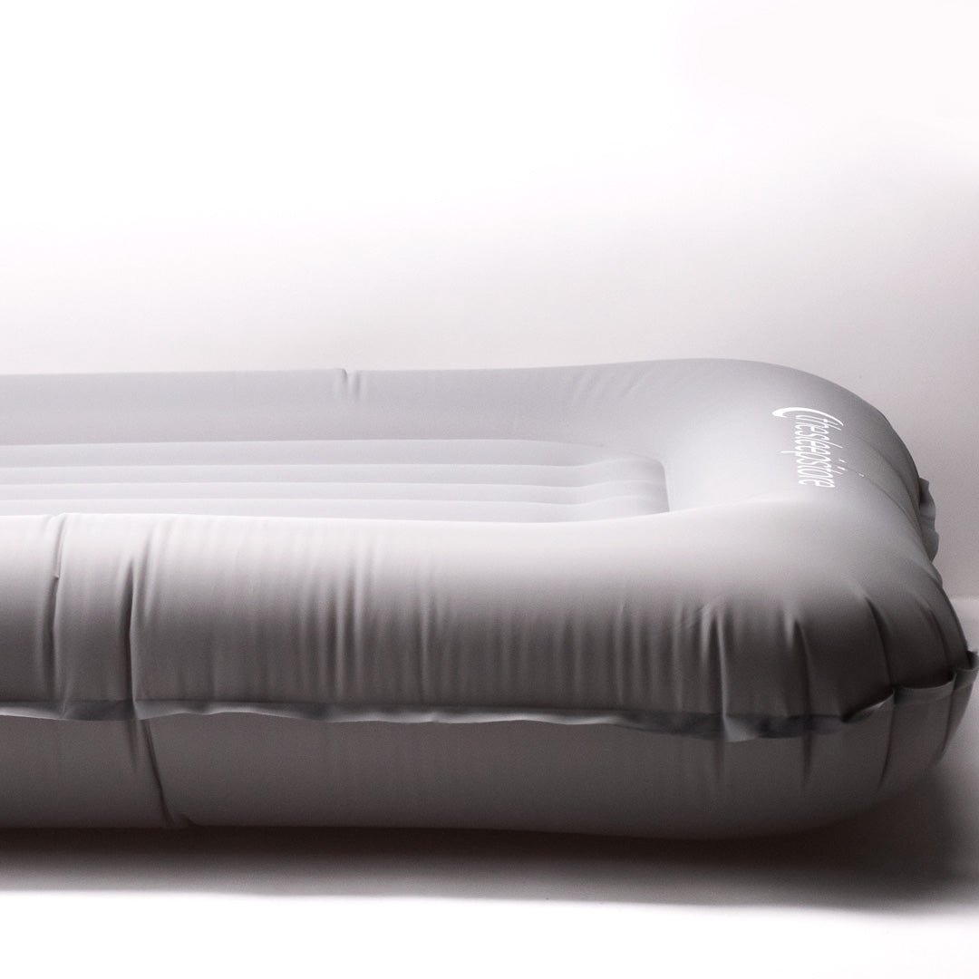 A close up, side shot image of The Sleep Store Dream Inflatable Kids Travel Bed.
