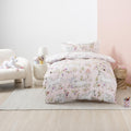 A room setting with a single bed displaying a duvet cover set, pink in colour with a magical unicorn print. 