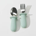 Blue Litill Lapsi fork and spoon against white background.