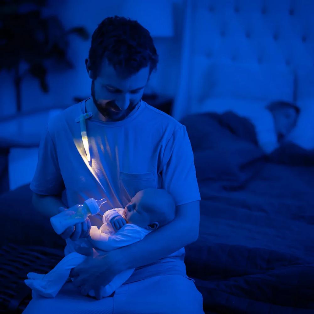 Dad feeding baby with latchlight.