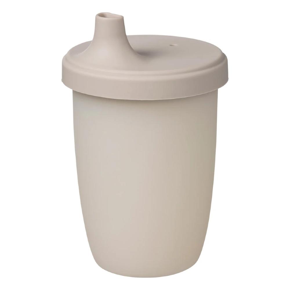 A matte, light beige silicone baby tumbler cup with a matching lid and integrated spout, shown on a solid white background.