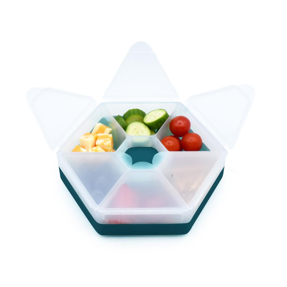 Hexagonal Melii food container with compartments filled with fruits and vegetables on a white background