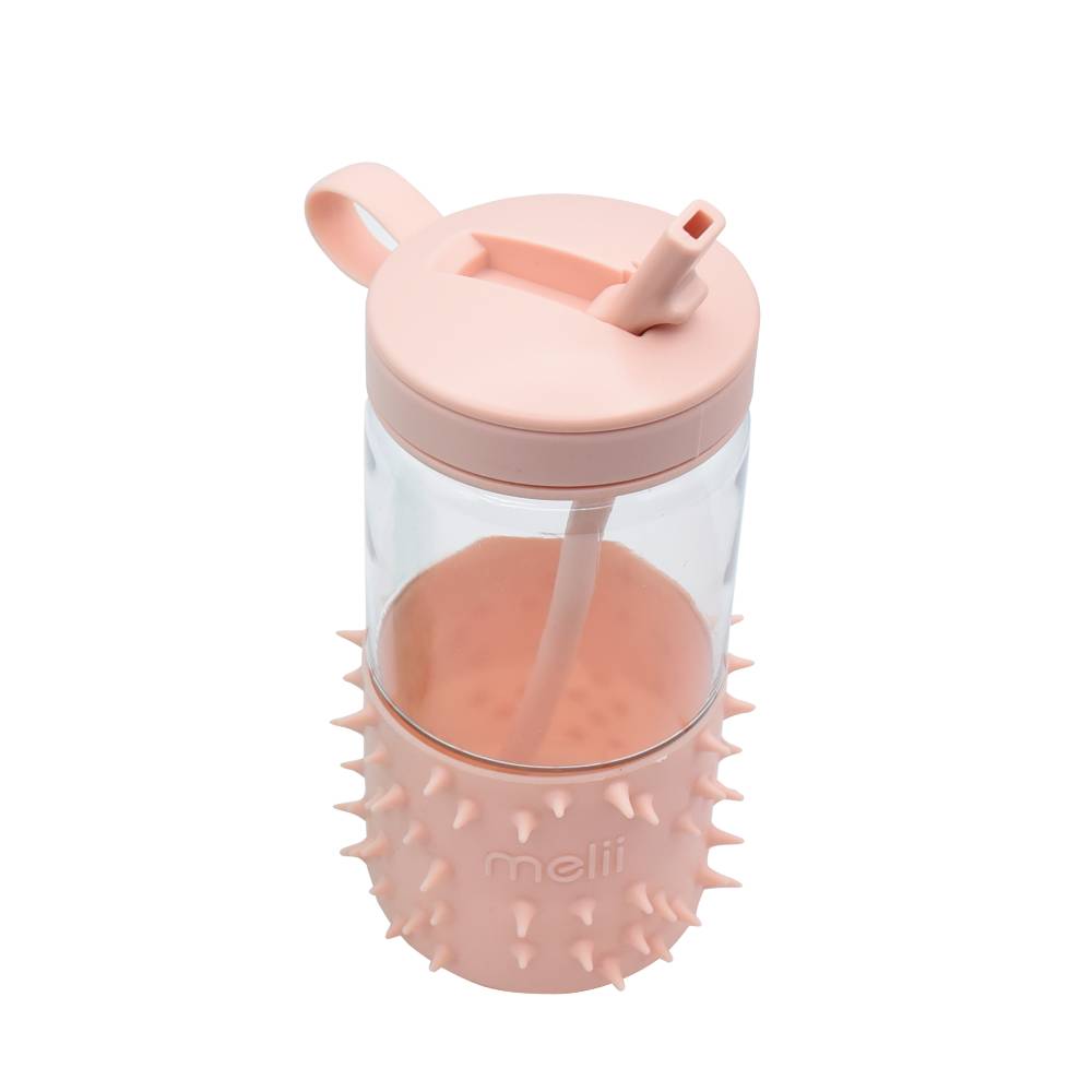Pink spiky drink bottle with a straw on a white background
