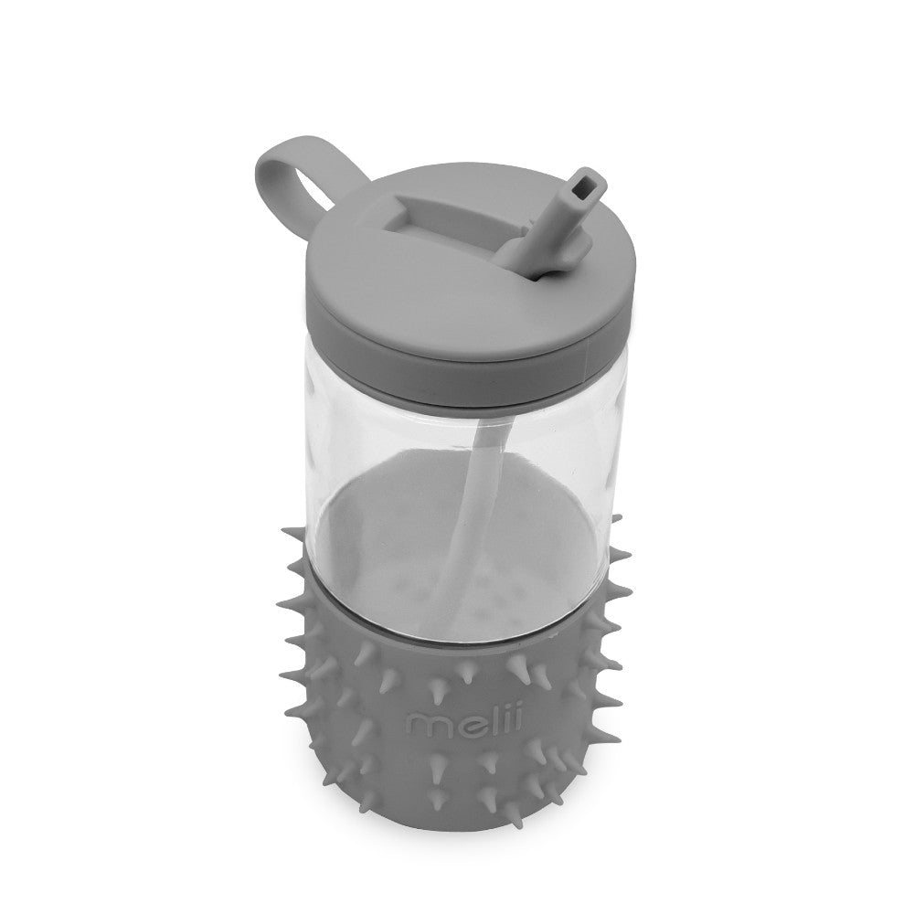 Clear drink container with gray lid and spiky base on a white background