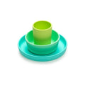 Set of green and turquoise silicone dishes on a white background