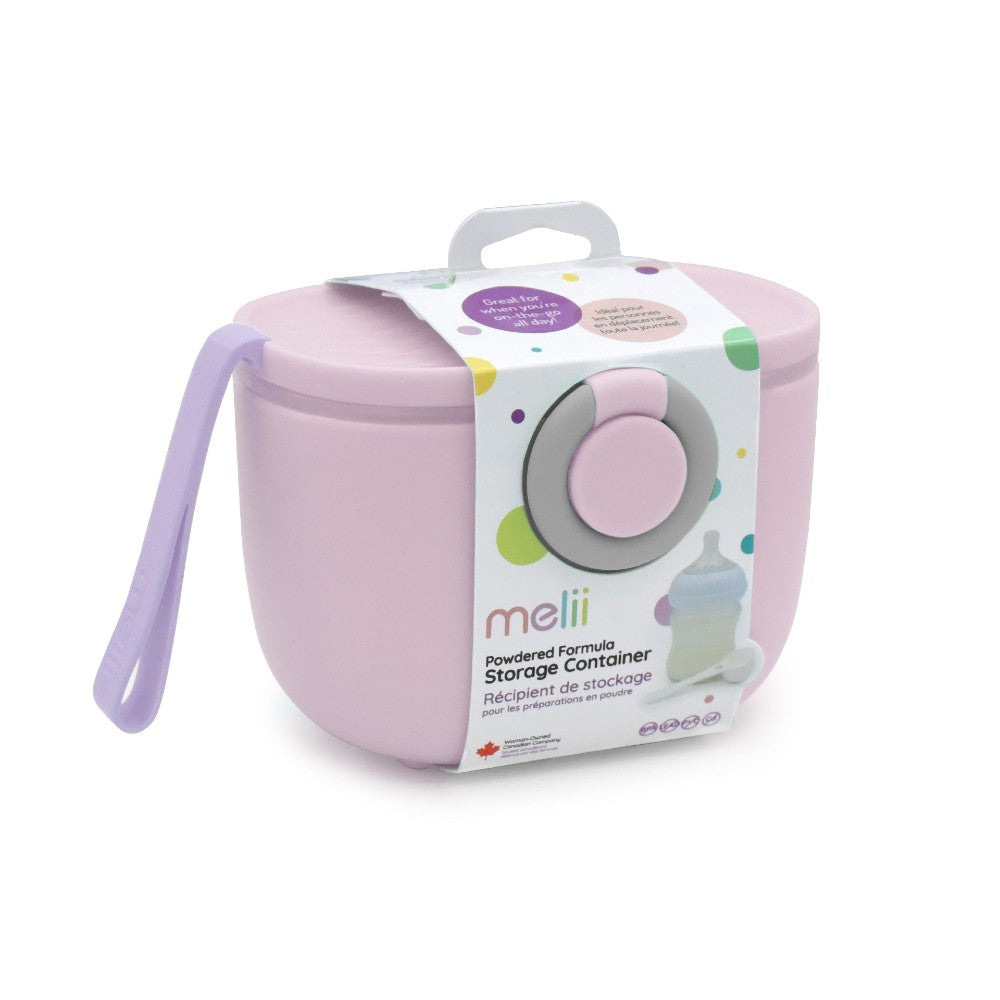 Pink powdered formula storage container with packaging on a white background