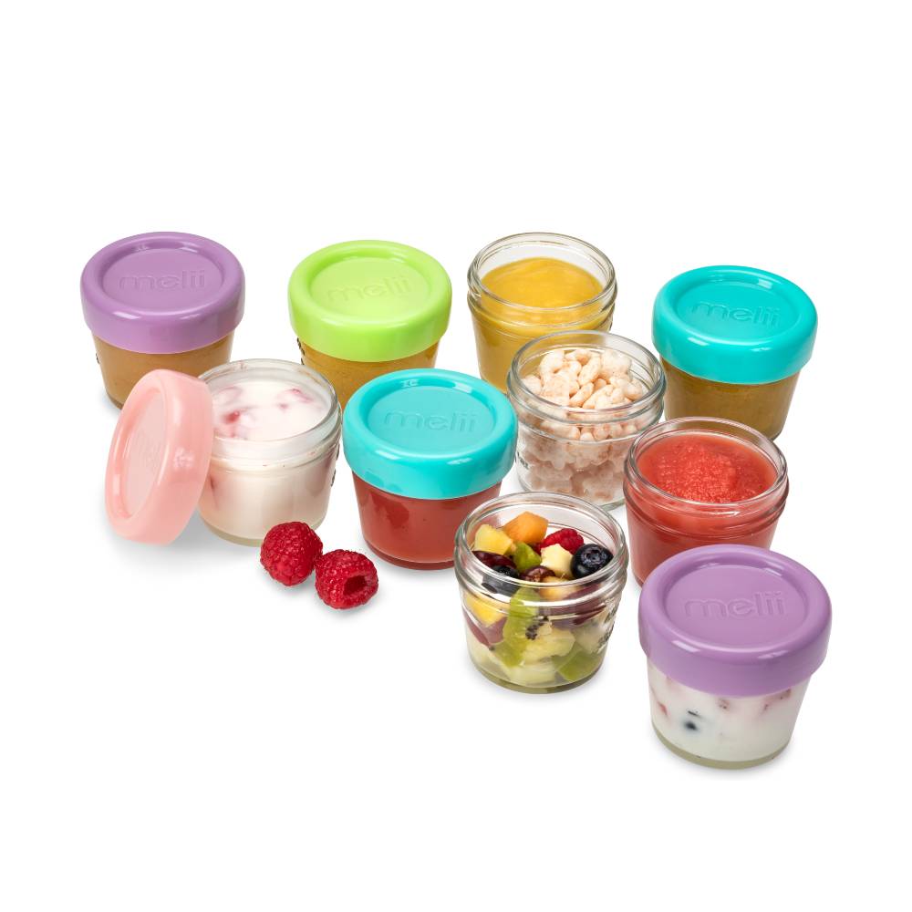 Set of glass jars with colorful lids containing various food items on a white background