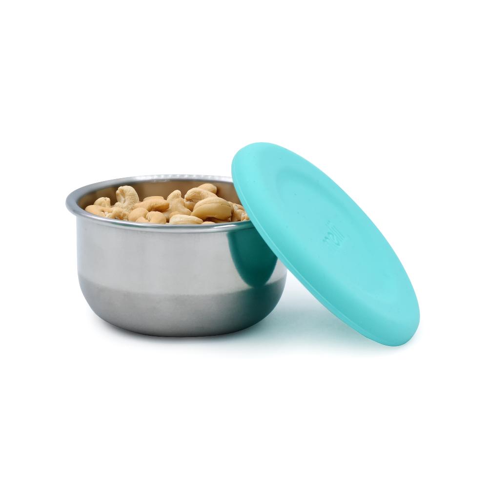 Metallic snack pot with turquoise lid containing peanuts on a white background