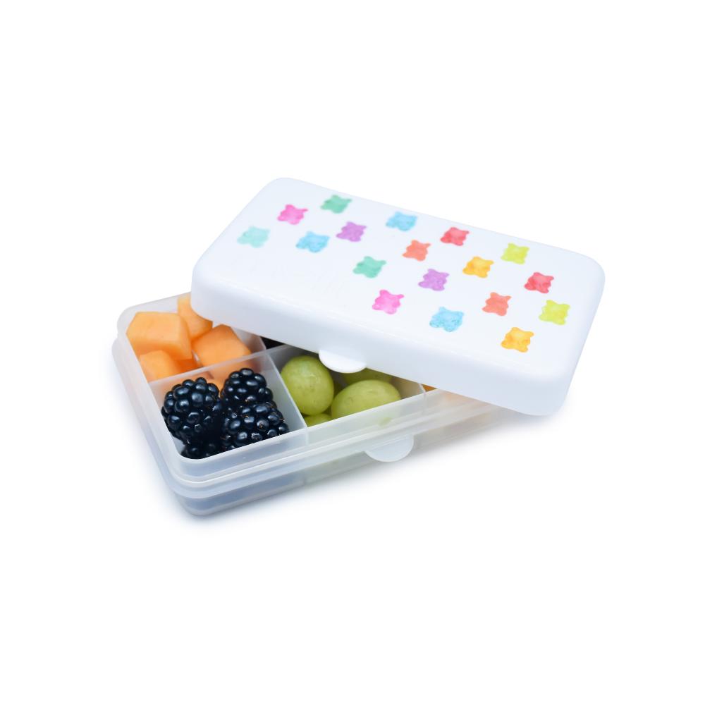 Small snack container with colorful lid and compartments filled with fruits on a white background