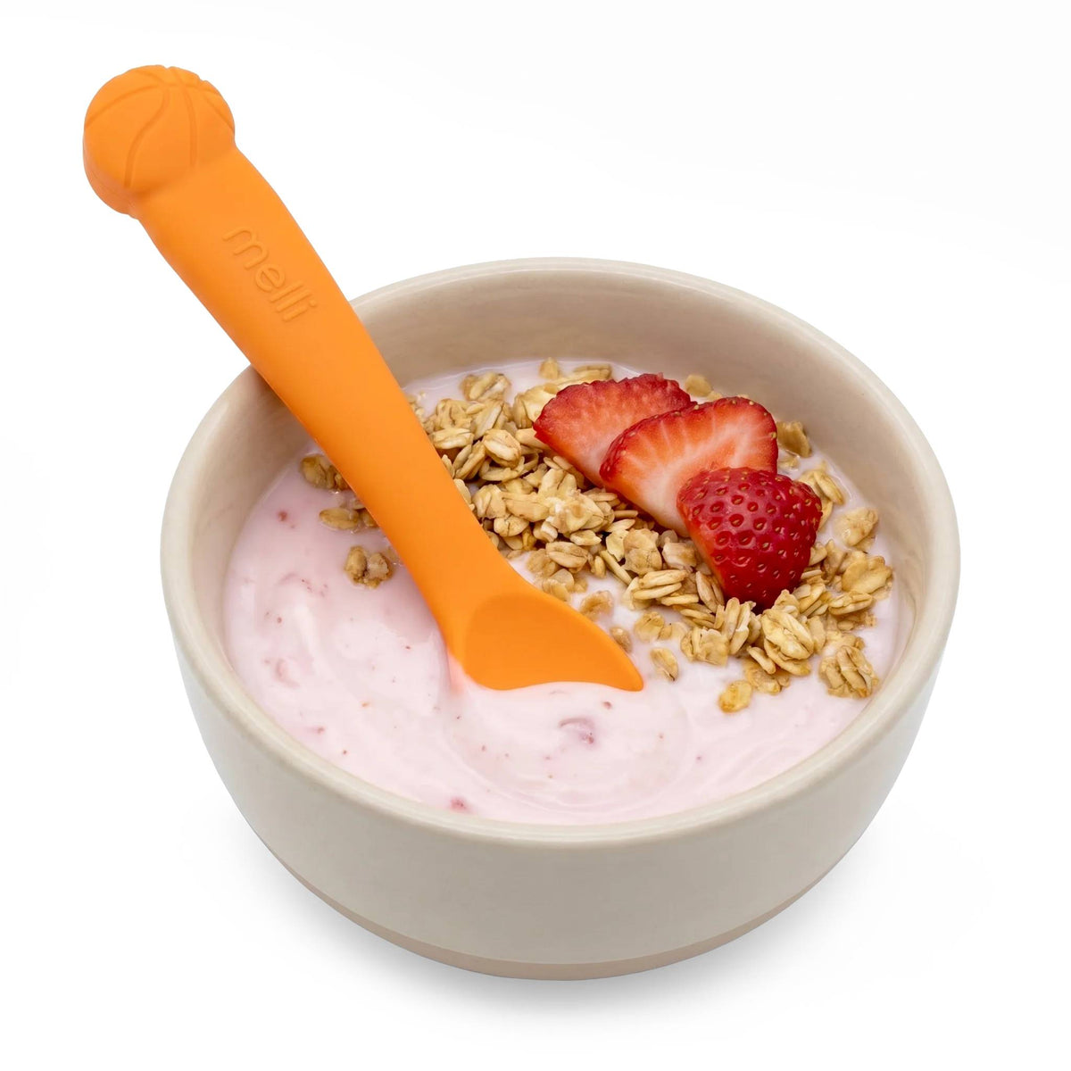 A bowl of granola, strawberries and yoghurt with an orange basketball theme silicone spoon. 