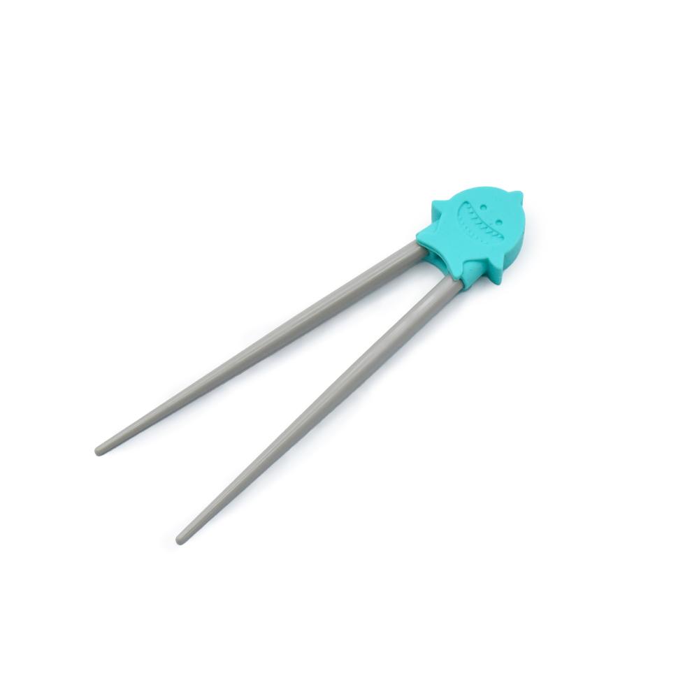 Children's chopsticks with teal shark  on a white background