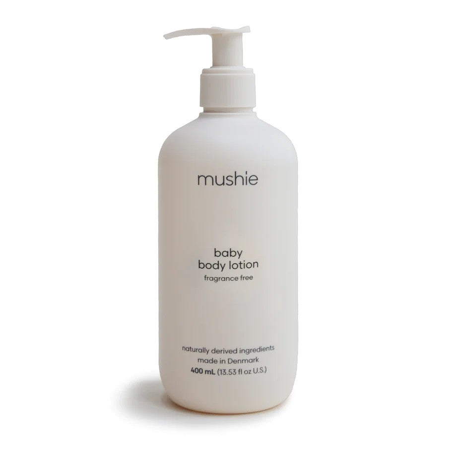 White bottle of mushie baby body lotion on a white background