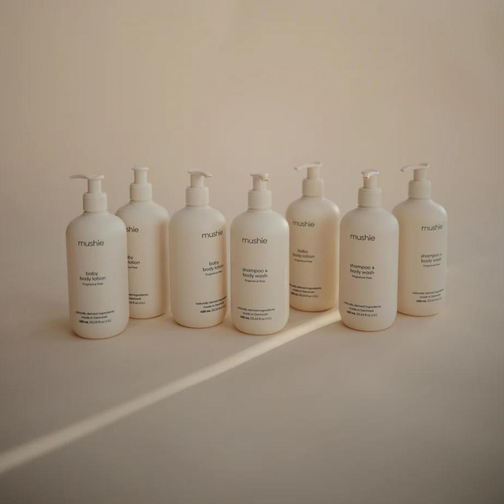 Row of white bottles with pump dispensers on a beige background