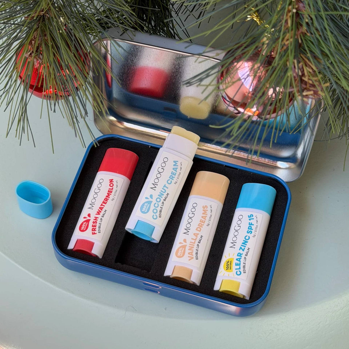 A tin containing 4 tubes of Lip Balms. 