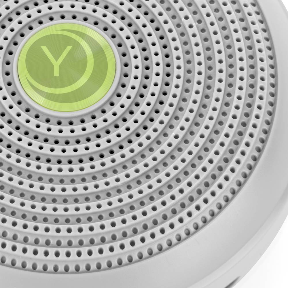 Close up of Yogasleep Hushh white noise machine on a white background