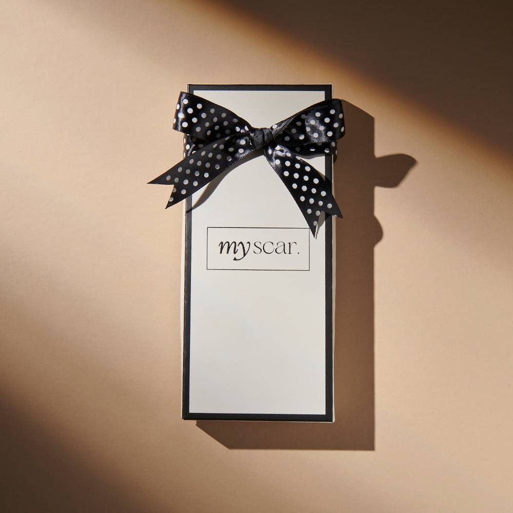 Myscar box against beige background.