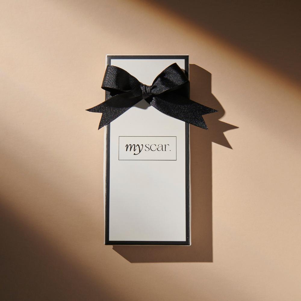 Myscar box against beige background.
